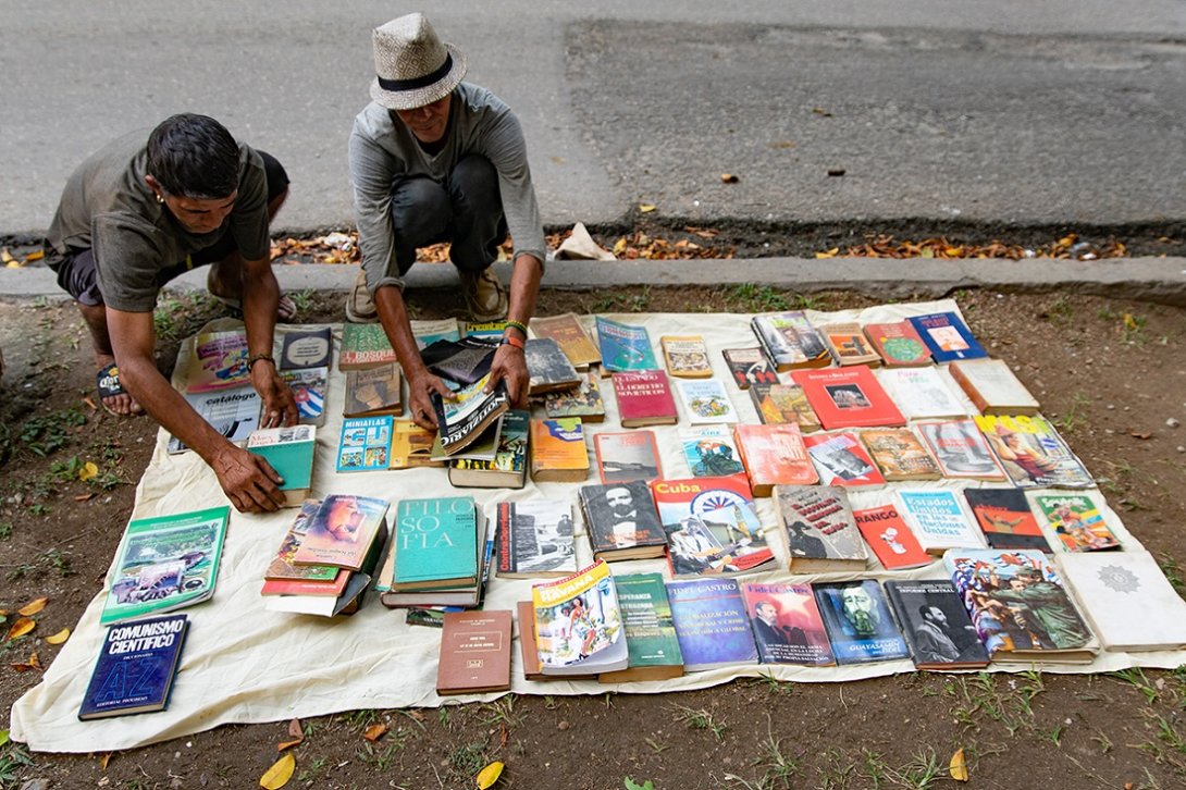 De un saco empiezan a sacar libros con un fuerte olor a basurero.