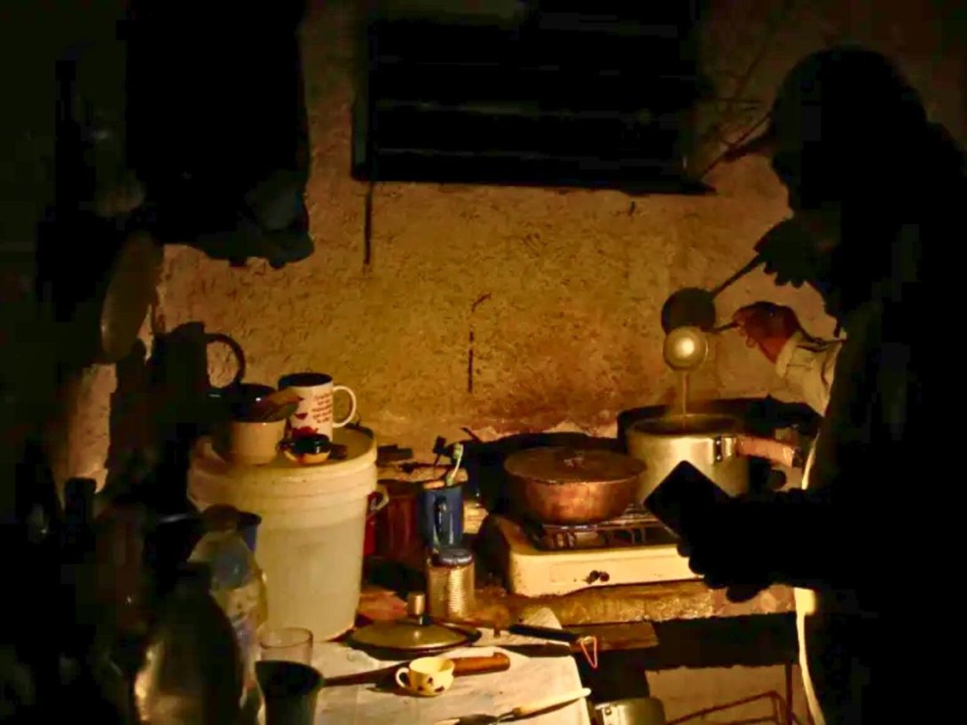 Cubano cocinando en medio de un apagón nocturno. Foto de Reuters.