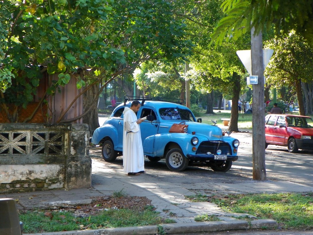 Un sacerdote leyendo en la calle.