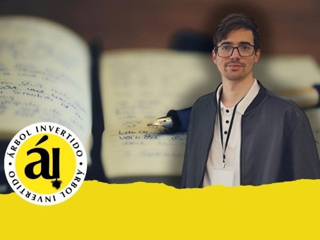 Retrato de Senén Alonso Alum, periodista y editor vinculado a la revista Árbol Invertido, de pie con mochila y camiseta oscura, sobre un fondo difuminado de cuadernos manuscritos.