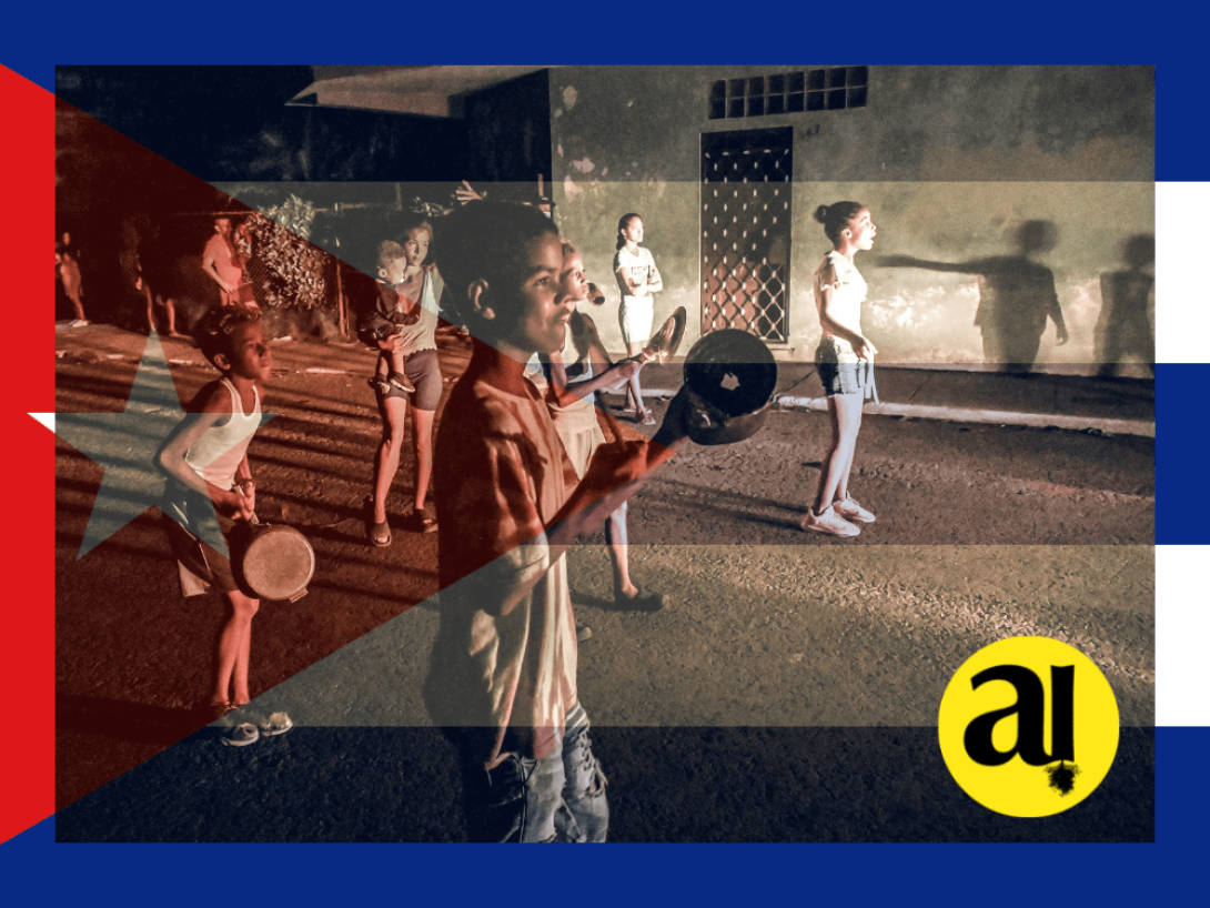 Personas manifestándose en La Habana. Bandera cubana detrás.