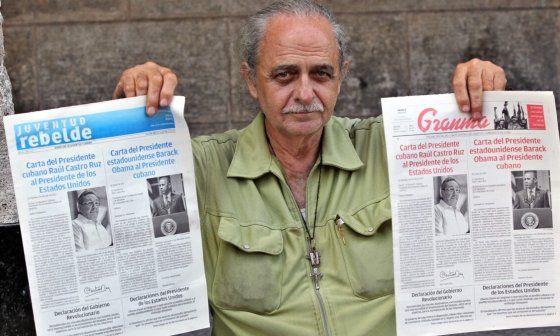 Ciudadano cubano sostiene un periódico Granma y otro Juventud Rebelde