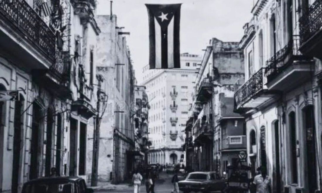 Bandera cubana colgada en medio de una calle habanera.